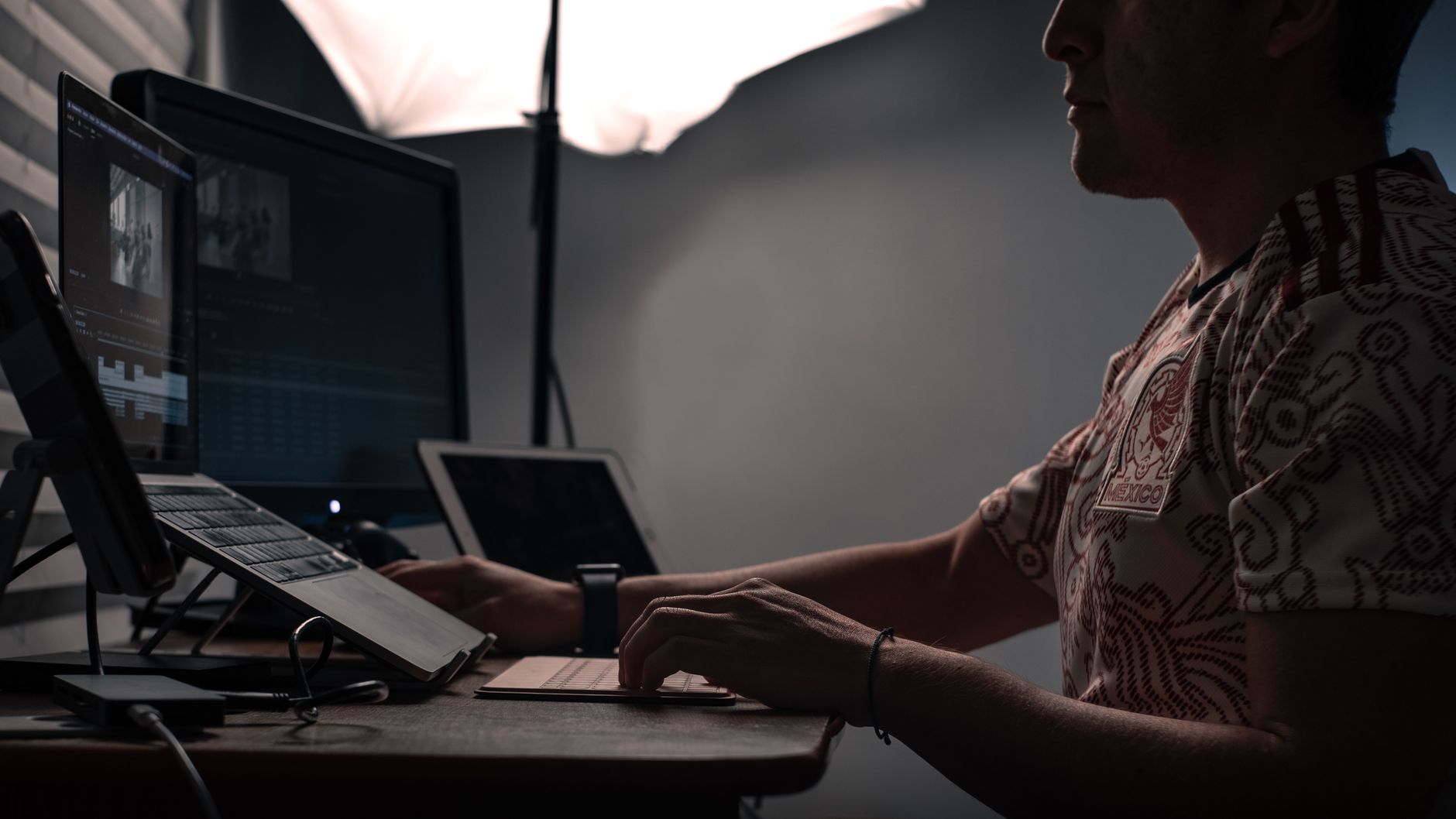 A split screen on a modern laptop showing OpenAI's ChatGPT interface on the left and Anthropic's Claude workspace on the right